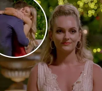 Nichole glances away while a couple hugs in the background on "Bachelor 2019," night setting with green bokeh.