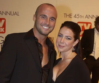 Two people smiling at an event; wearing formal attire; TV Week backdrop; 45th Annual Logie Awards.
