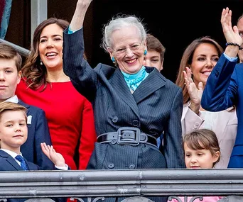 Royal family group on balcony waving to the crowd.