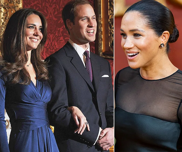 Two women and a man smiling together at a formal event.