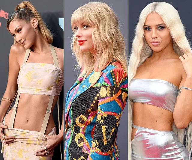 Alt text: "Three women in stylish outfits pose on the red carpet at the 2019 MTV VMAs."