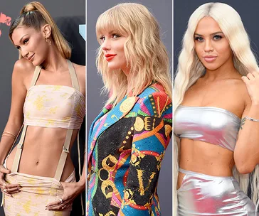 Alt text: "Three women in stylish outfits pose on the red carpet at the 2019 MTV VMAs."