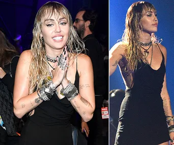 Miley Cyrus at VMAs 2019, wearing a black dress and layered jewelry, smiling and performing on stage.