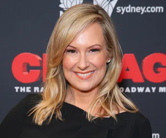 A person smiling at a "Chicago" musical event backdrop.