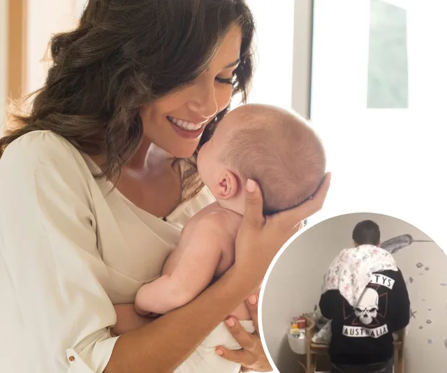 Woman smiling at baby she holds; inset of adult with baby blanket; jacket reads "Australia" with skull logo.