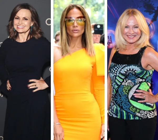 Women over 50 in stylish outfits: navy dress, orange one-shoulder dress with sunglasses, and patterned top at a blue-lit event.