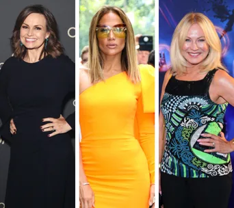 Women over 50 in stylish outfits: navy dress, orange one-shoulder dress with sunglasses, and patterned top at a blue-lit event.