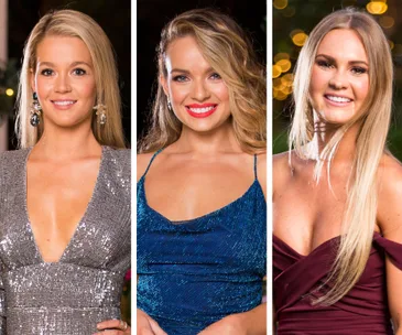 Three women dressed in sparkly gowns, smiling, and posing for a formal photo at an event or gathering.