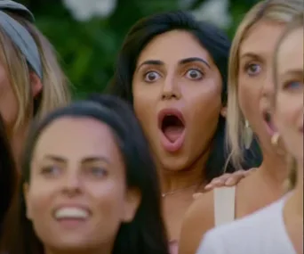 Women look surprised, wide-eyed, and with open mouths in a reaction scene from "The Bachelor" 2019 episode.
