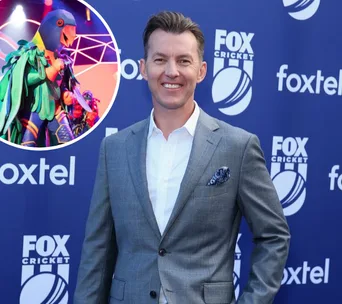 "Person in a gray suit at a Fox Cricket event, with an inset of a vibrant, masked character costume."