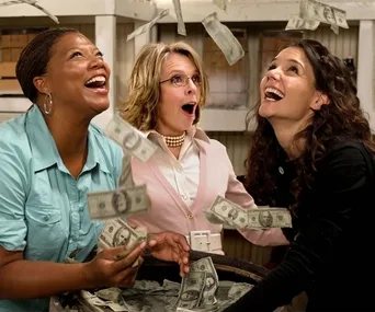Three women joyfully catch money falling from above, surrounded by cash in a light-hearted scene.