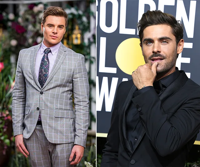 Two men in suits; one in a gray plaid suit, the other in a black suit at an event with "GOLDEN LOVE" in the background.