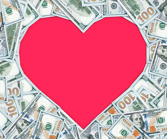 Dollar bills forming a heart shape with a pink center.