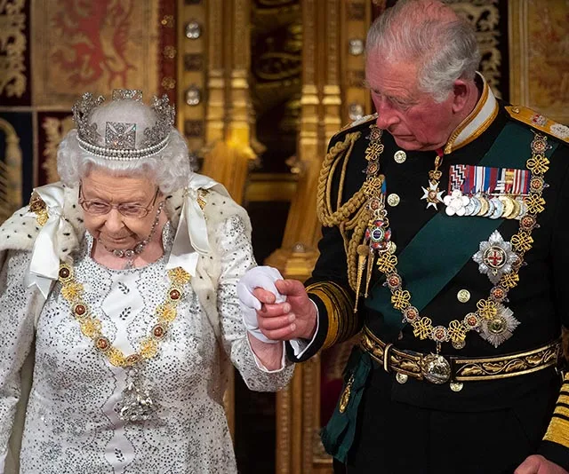 Queen Elizabeth II and a man in military attire at a formal event.
