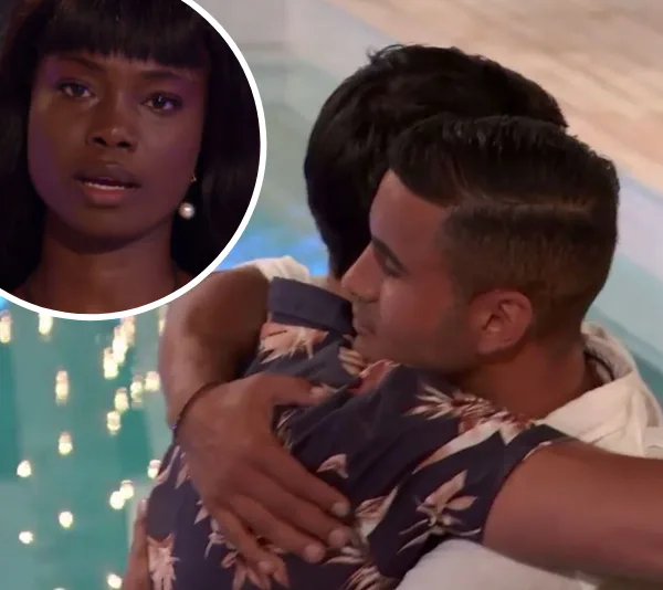 Participants hugging with emotional expression during a Love Island elimination scene.