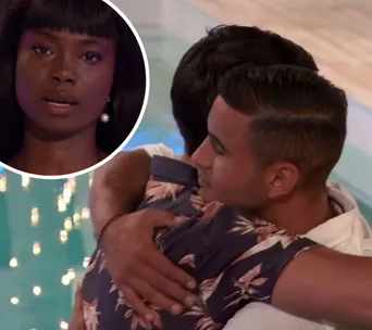 Participants hugging with emotional expression during a Love Island elimination scene.