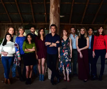 Cast of "Doctor Doctor" Season 4 poses together in a rustic barn setting, showcasing characters in casual attire.