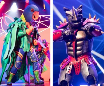 Two colorful contestants in elaborate costumes from "The Masked Singer" on stage with vibrant lighting.