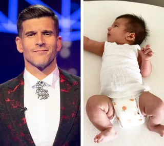 Man in a suit smiling on the left; baby in a white outfit lying down on the right.