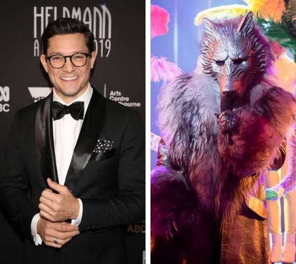 Rob Mills at an event in a tuxedo next to a person in a wolf costume on a colorful stage.