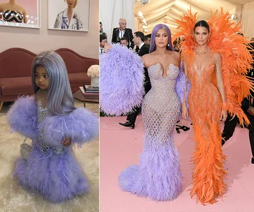 Child in a purple feathered gown next to an adult in a matching dress with another person in an ornately feathered orange outfit.