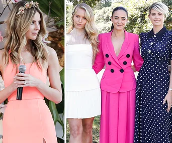 Women in stylish dresses pose outdoors; one in coral holding a mic, three in white, pink, and navy polka dots stand together.