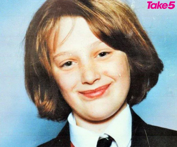 A young person with short hair smiling, wearing a school uniform, with a logo "Take5" in the corner.