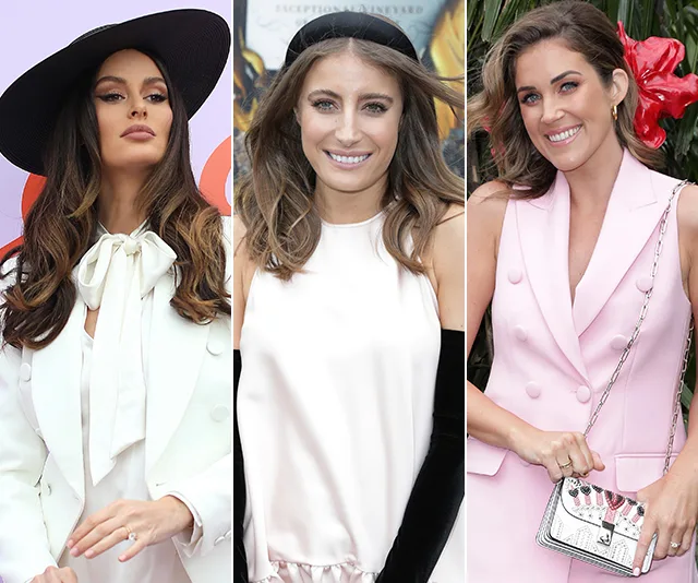 Three women in stylish outfits at Oaks Day 2019, wearing a white suit with hat, a satin dress, and a pink vest dress.