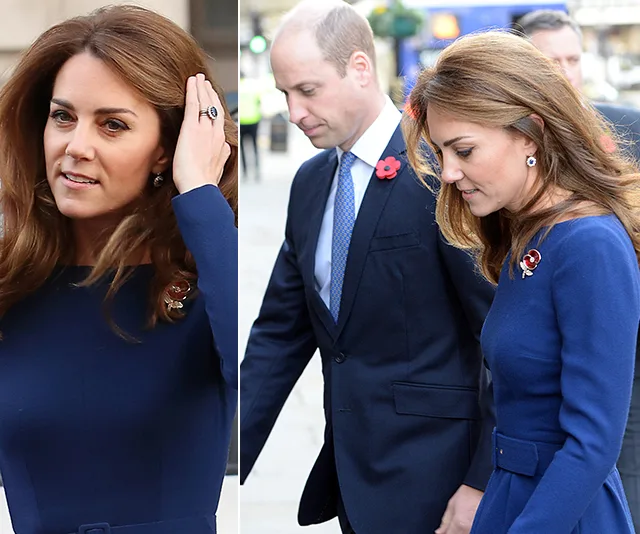 Kate Middleton in a blue dress with earrings, walking outdoors with Prince William.