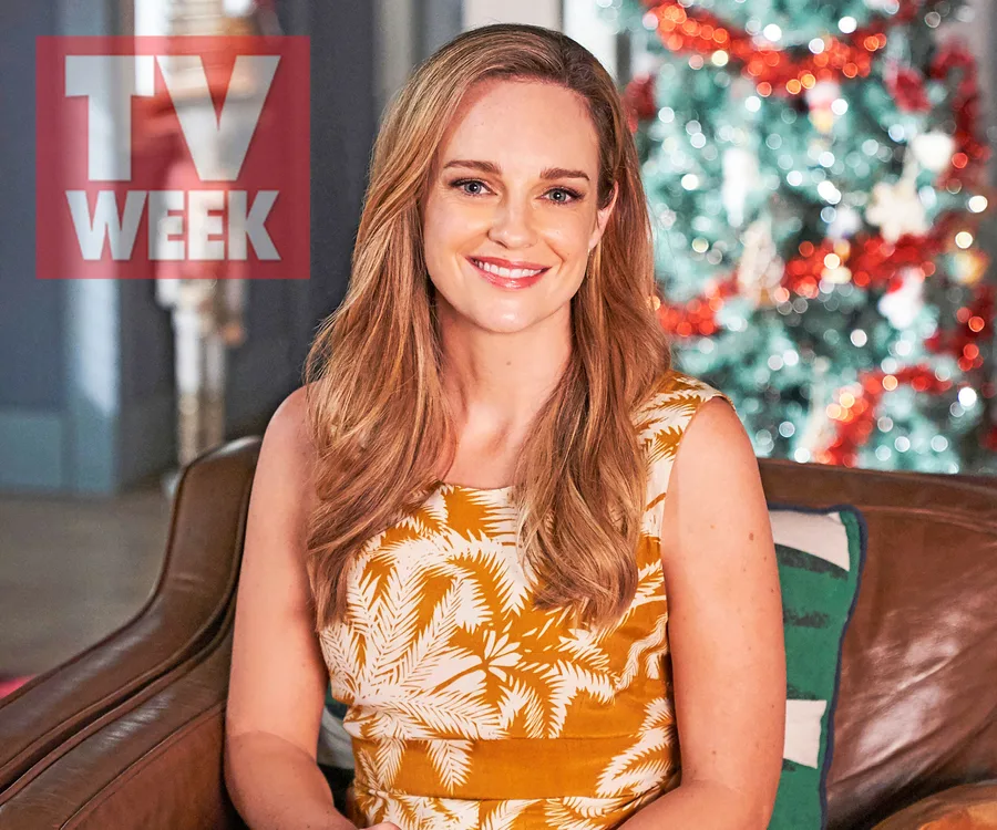 Penny McNamee in a floral dress smiles in front of a Christmas tree, with TV Week logo in the corner.