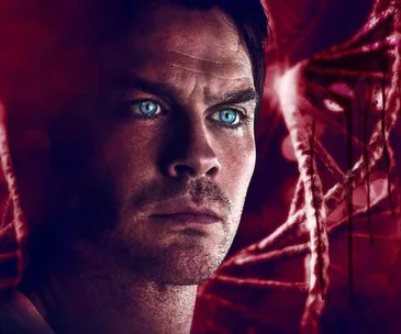 Ian Somerhalder in a dramatic red filter scene from Netflix's "V Wars," with intense blue eyes focused forward.