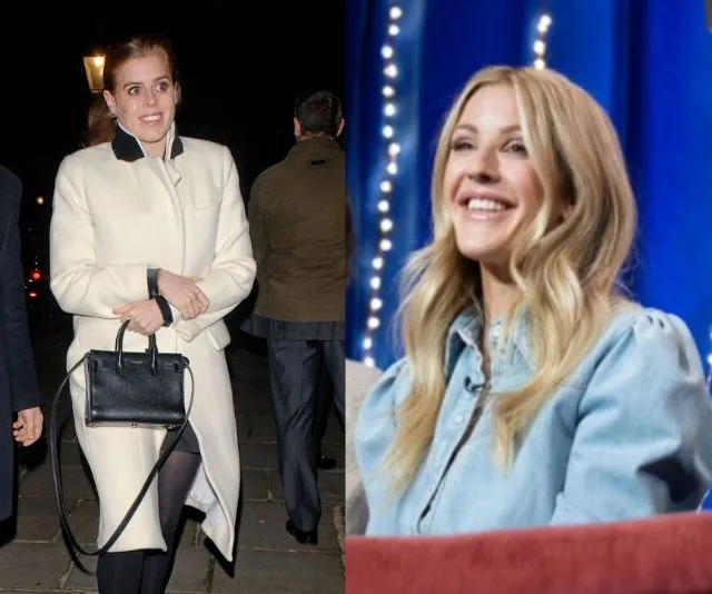 Two women, one in a white coat holding a black purse, the other smiling in a denim shirt, seated indoors.