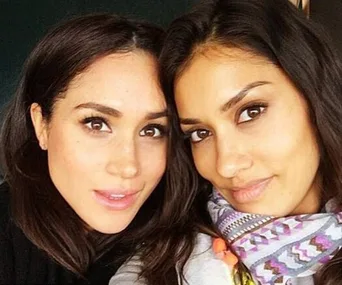 Two women smiling closely at the camera.