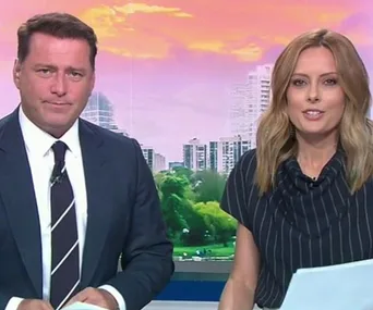 Today Show hosts sitting at the desk with a cityscape background.