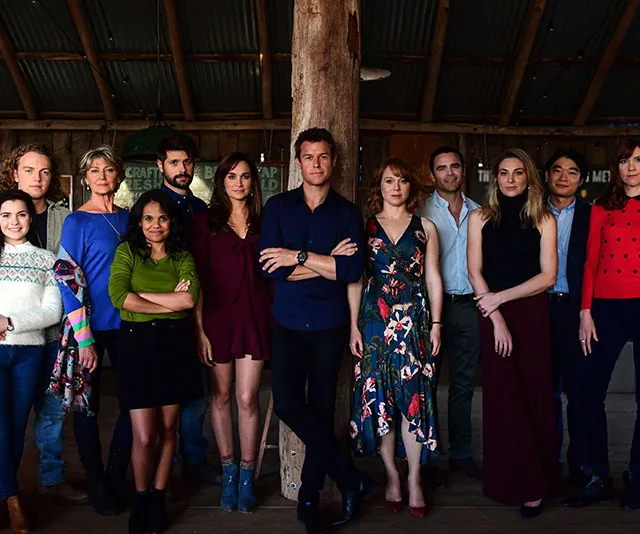 Cast of "Doctor Doctor" season four posing together in a rustic indoor setting, dressed in casual and formal attire.