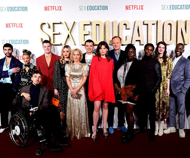 Cast of "Sex Education" posing together at a red carpet event with a "Netflix" and "Sex Education" backdrop.
