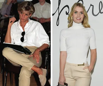 Two women in similar outfits: one in a white shirt and beige pants, seated; the other in a white turtleneck and beige pants, standing.