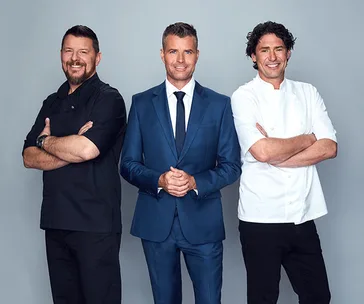 Three hosts from My Kitchen Rules 2020, standing together and smiling.