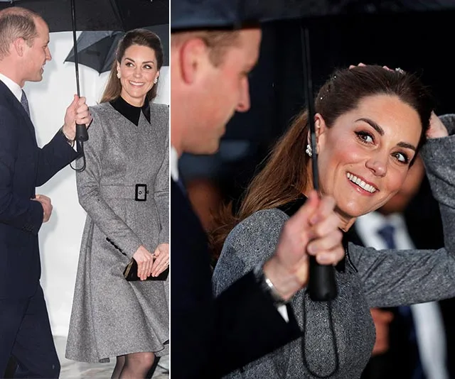 Kate Middleton at Holocaust Memorial Day, wearing a gray coat dress, smiling and holding an umbrella.