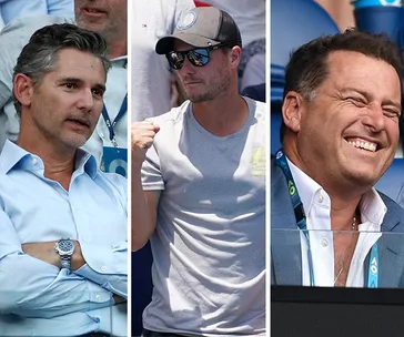 Three men in crowd at Australian Open 2020. One in shirt, one in cap, one smiling. Spectators enjoying match.