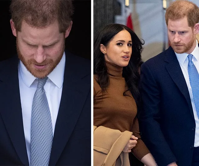 Prince Harry in a suit, looking down; beside, with Meghan Markle in a brown top, holding a coat, both walking indoors.