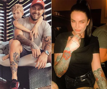 "Two people with tattoos; smiling man with child, and woman with sleeve tattoos seated indoors."