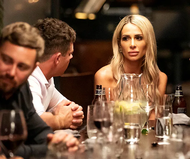 Stacey Hampson sitting at a dinner table with others, looking pensive.