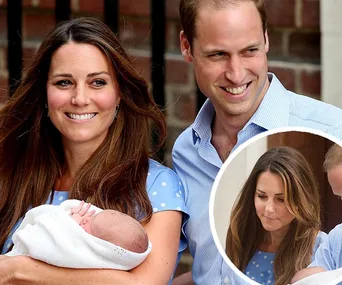 Kate holding a newborn wrapped in a white blanket, standing with William, both smiling outside a building.