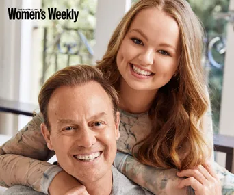 Man and woman smiling warmly indoors, featured in Australian Women's Weekly.