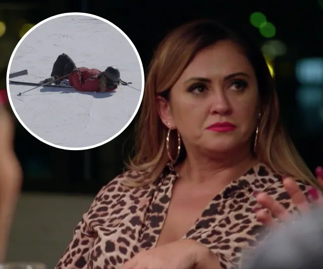 A woman in a leopard print top looks concerned at a dinner table. Inset shows a person lying on snow in ski gear.