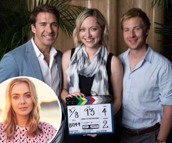 Actors posing with a clapperboard on the "Back to the Rafters" set, inset photo of a smiling woman.