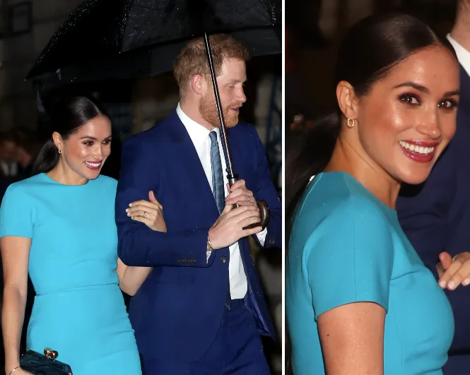 Couple in formal attire, with the woman in a blue dress and man in a suit with an umbrella, at a public event.