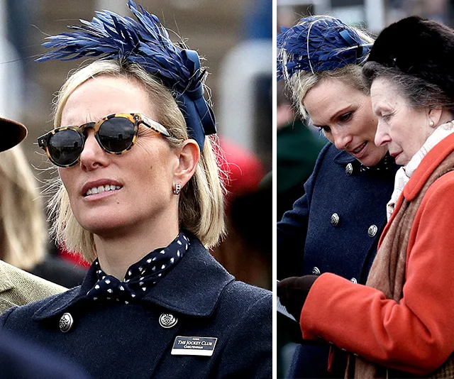 Zara Tindall in a navy coat and matching feathered hat, wearing sunglasses, at a racing event with an older woman in an orange coat.
