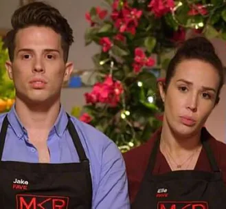Two "My Kitchen Rules" contestants, Jake and Elle, wearing aprons, with flowers in the background.